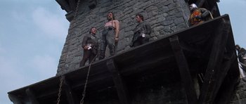Movie still from “Macbeth” (1971), directed by Roman Polanski – A group of men standing next to each other on a wall; Wide shot, Low angle