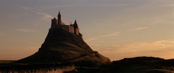 Movie still from “Macbeth” (1971), directed by Roman Polanski – A castle on top of a hill at sunset; Extreme Wide shot, Low angle