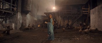 Movie still from “Macbeth” (1971), directed by Roman Polanski – A woman standing in the middle of an old town; Wide shot, Low angle