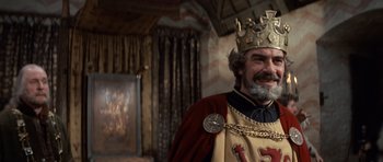 Movie still from “Macbeth” (1971), directed by Roman Polanski – A person wearing a costume and a crown; Medium shot, Low angle