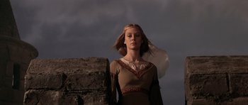 Movie still from “Macbeth” (1971), directed by Roman Polanski – A woman standing in front of a stone wall; Medium shot, Low angle