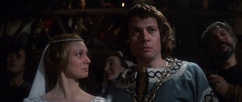 Movie still from “Macbeth” (1971), directed by Roman Polanski – A man and a woman in medieval garb in front of a crowd; Close Up shot, Over the shoulder angle