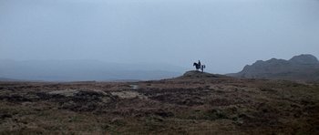 Movie still from “Macbeth” (1971), directed by Roman Polanski – A person riding a horse on top of a hill; Extreme Wide shot, Low angle