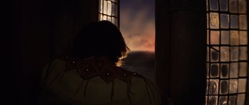 Movie still from “Macbeth” (1971), directed by Roman Polanski – A woman looking out of a window at the sunset; Medium shot, Over the shoulder angle