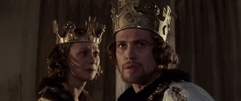 Movie still from “Macbeth” (1971), directed by Roman Polanski – A man and a woman wearing crowns in a room; Close Up shot, Low angle