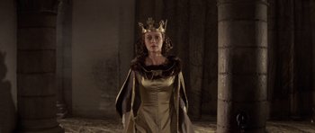 Movie still from “Macbeth” (1971), directed by Roman Polanski – A woman wearing a crown standing in a room; Medium shot, Low angle
