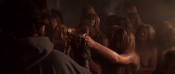 Movie still from “Macbeth” (1971), directed by Roman Polanski – A group of people gathered around a bowl; Medium shot, High angle