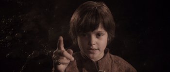Movie still from “Macbeth” (1971), directed by Roman Polanski – A young boy is pointing his finger at the camera; Close Up shot, High angle