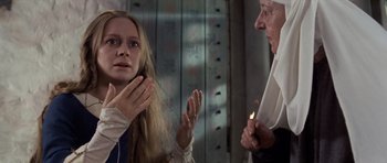 Movie still from “Macbeth” (1971), directed by Roman Polanski – A woman and an old man are talking to each other; Medium shot, Low angle