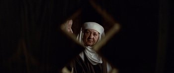 Movie still from “Macbeth” (1971), directed by Roman Polanski – An old woman wearing a white head covering; Close Up shot, Over the shoulder angle