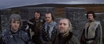 Movie still from “Macbeth” (1971), directed by Roman Polanski – A group of men standing next to each other on top of a hill; Medium shot, Low angle
