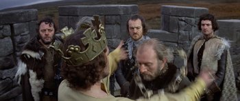 Movie still from “Macbeth” (1971), directed by Roman Polanski – Two men in medieval garb and a man with a beard; Medium shot, Over the shoulder angle
