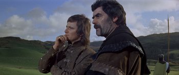 Movie still from “Macbeth” (1971), directed by Roman Polanski – A man and a woman standing next to each other; Medium shot, Low angle