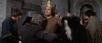 Movie still from “Macbeth” (1971), directed by Roman Polanski – A man wearing a gold crown and a leather jacket; Medium shot, Low angle