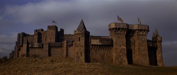 Movie still from “Macbeth” (1971), directed by Roman Polanski – An old castle is shown with a dark sky in the background; Extreme Wide shot, Low angle