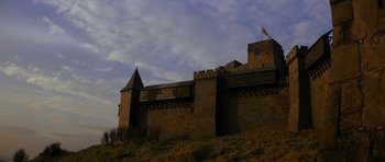 Movie still from “Macbeth” (1971), directed by Roman Polanski – A castle like building on top of a grassy hill; Extreme Wide shot, Low angle