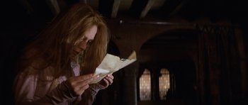 Movie still from “Macbeth” (1971), directed by Roman Polanski – A woman looking at an envelope in her hands; Close Up shot, High angle