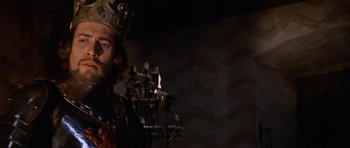 Movie still from “Macbeth” (1971), directed by Roman Polanski – A man wearing a crown standing in front of a wall; Close Up shot, Low angle