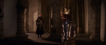 Movie still from “Macbeth” (1971), directed by Roman Polanski – Two men dressed in medieval costumes in front of a pillar; Medium shot, Over the shoulder angle