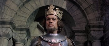 Movie still from “Macbeth” (1971), directed by Roman Polanski – A person wearing a suit of armor and a crown; Close Up shot, Low angle