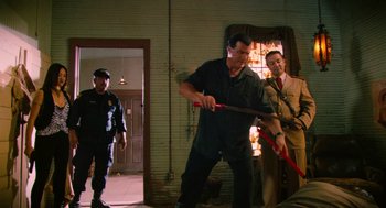 Movie still from “Machete” (2010), directed by Robert Rodriguez – A group of men standing in a room; Wide shot, Low angle