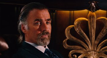 Movie still from “Machete” (2010), directed by Robert Rodriguez – A person wearing a suit and tie; Close Up shot, Low angle