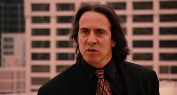 Movie still from “Machete” (2010), directed by Robert Rodriguez – A person wearing a suit and tie; Close Up shot, Over the shoulder angle