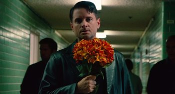 Movie still from “Machete” (2010), directed by Robert Rodriguez – A man holding a bunch of flowers in his hand; Close Up shot, Low angle