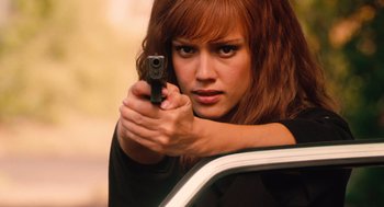 Movie still from “Machete” (2010), directed by Robert Rodriguez – A beautiful woman holding a gun while standing next to a car; Close Up shot, Over the shoulder angle