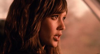 Movie still from “Machete” (2010), directed by Robert Rodriguez – A young woman's face in a dark room; Close Up shot, Low angle