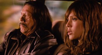 Movie still from “Machete” (2010), directed by Robert Rodriguez – A man and a woman sitting in the back of a car; Close Up shot, Over the shoulder angle