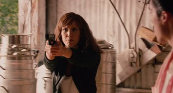 Movie still from “Machete” (2010), directed by Robert Rodriguez – A woman is holding a gun in her hand; Medium shot, Low angle