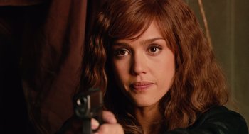 Movie still from “Machete” (2010), directed by Robert Rodriguez – A woman holding a gun while looking at the camera; Close Up shot, Over the shoulder angle