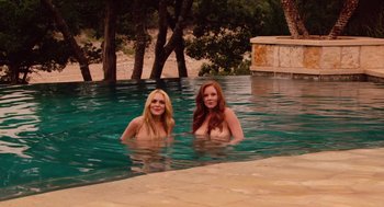 Movie still from “Machete” (2010), directed by Robert Rodriguez – Two women in a pool with trees in the background; Wide shot, High angle