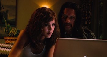 Movie still from “Machete” (2010), directed by Robert Rodriguez – A woman and a man are looking at a laptop computer; Close Up shot, Over the shoulder angle