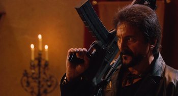 Movie still from “Machete” (2010), directed by Robert Rodriguez – A man holding a gun up to his face; Medium shot, Low angle