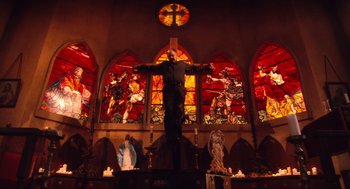 Movie still from “Machete” (2010), directed by Robert Rodriguez – A man standing in front of a stained glass window; Wide shot, Low angle