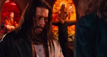 Movie still from “Machete” (2010), directed by Robert Rodriguez – A man with long black hair and a long beard; Medium shot, Low angle