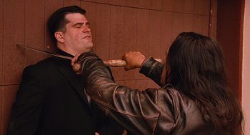 Movie still from “Machete” (2010), directed by Robert Rodriguez – A man and a woman are fighting with a wooden stick; Medium shot, Over the shoulder angle