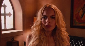 Movie still from “Machete” (2010), directed by Robert Rodriguez – A woman with long blonde hair stares into the camera; Close Up shot, Over the shoulder angle