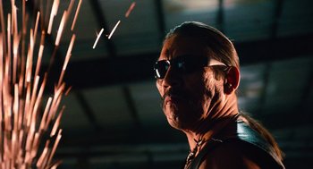 Movie still from “Machete” (2010), directed by Robert Rodriguez – A person wearing sunglasses; Close Up shot, Low angle