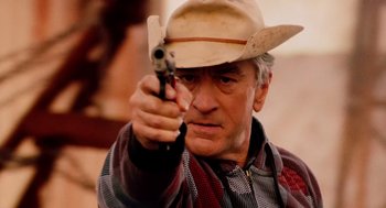 Movie still from “Machete” (2010), directed by Robert Rodriguez – A man in a cowboy hat is holding a gun; Close Up shot, Low angle