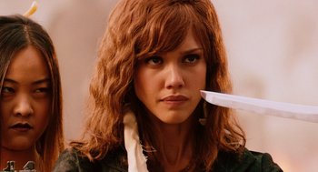 Movie still from “Machete” (2010), directed by Robert Rodriguez – A woman holding a knife in her mouth; Close Up shot, Over the shoulder angle