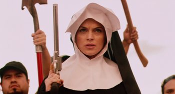 Movie still from “Machete” (2010), directed by Robert Rodriguez – A woman dressed as a nun holding a gun; Close Up shot, High angle