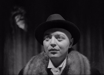 Movie still from “Mad Love” (1935), directed by Karl Freund – A man wearing a fur coat and a hat; Close Up shot, Low angle