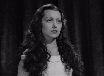 Movie still from “Mad Love” (1935), directed by Karl Freund – A black and white photo of a woman with long curly hair; Close Up shot, High angle