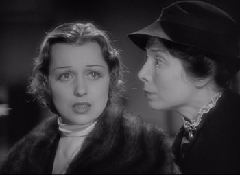 Movie still from “Mad Love” (1935), directed by Karl Freund – Two women are talking to each other in a black and white photo; Close Up shot, High angle