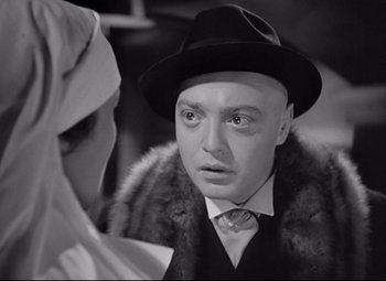 Movie still from “Mad Love” (1935), directed by Karl Freund – A man wearing a fur coat and a hat; Close Up shot, Over the shoulder angle