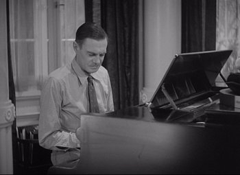 Movie still from “Mad Love” (1935), directed by Karl Freund – A black and white photo of a man playing the piano; Medium shot, High angle