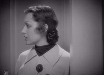 Movie still from “Mad Love” (1935), directed by Karl Freund – A black and white photo of a woman looking at herself in the mirror; Close Up shot, Over the shoulder angle